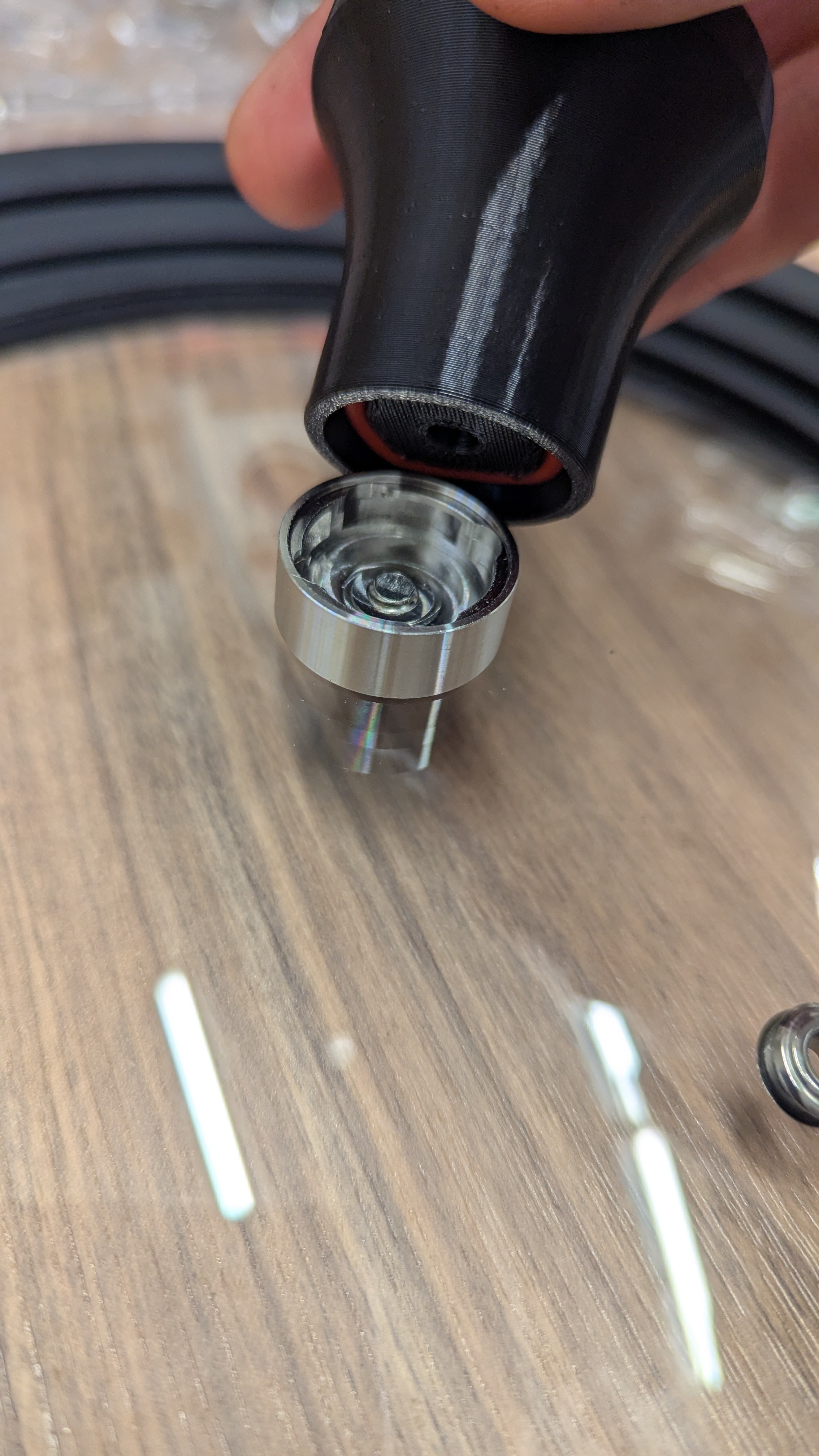 Screwing the top portion of the handle back on clockwise